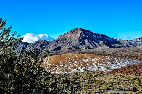 A mountain range with a snow covered peak Stock Photos