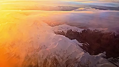 A mountain range with snow on it and a beautiful sunset in the background Stock Footage 270364976