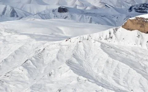 Mountain range in snow at sun winter day Stock Photos
