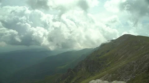 Mountain Range in Spring with Clouds 4K Stock Footage 64231473