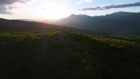 A mountain range with a sun shining on it Stock Footage 327963394