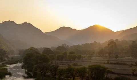 Mountain range with sunset dramatic orange sky at dusk from flat angle Foto stock