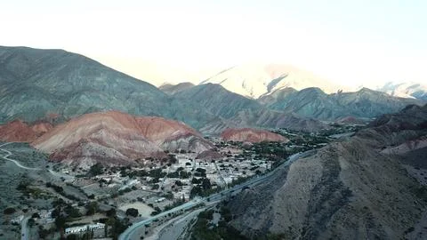 A mountain range with a town in the valley below Stock Photos