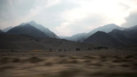 Mountain Range with Traffic, Sun Peaking Through Clouds near Yosemite, Driving Stock Footage 145456525