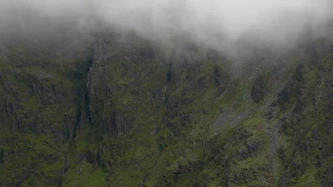 The mountain range is transformed into an enigmatic and moody landscape Stock Footage 255228918