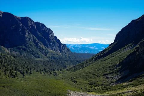A mountain range with trees and mountains in the background Stock Photos
