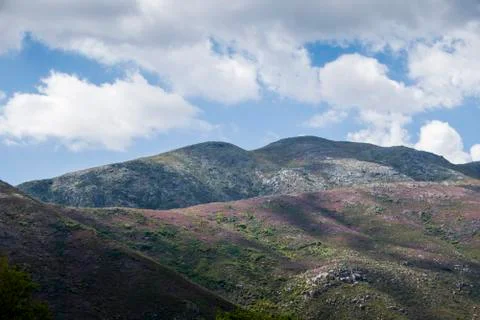 Mountain range under blue cloudy skies Stock Photos