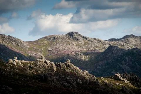 Mountain range under blue cloudy skies Stock Photos
