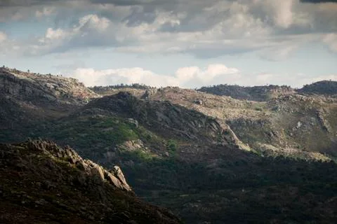 Mountain range under blue cloudy skies Stock Photos