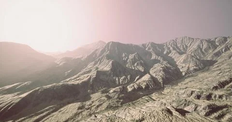Mountain range under a bright sky during early morning light in a remote area Illustrazione stock
