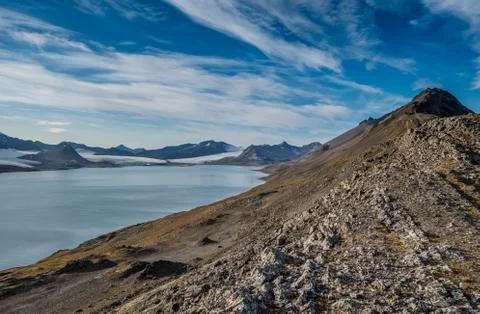 Mountain range under the clouds in Svalbard Stock Photos