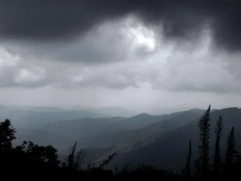 Mountain Range Under Dark Approaching Storm Stock Photos