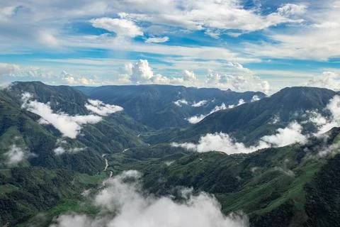 Mountain range valley filled with low clouds with dramatic sky at morning 写真素材