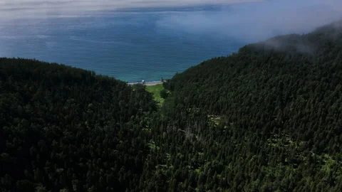 A mountain range with a view of the ocean. Aerial view of a lake in the Stock Footage 229551281