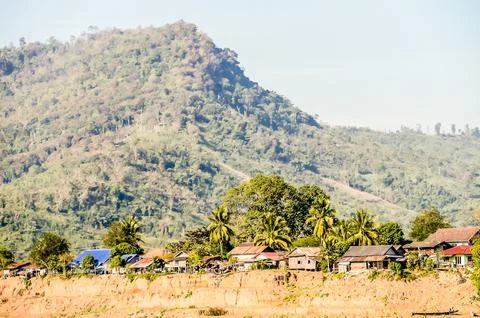 A mountain range with a village in the valley below Stock Photos