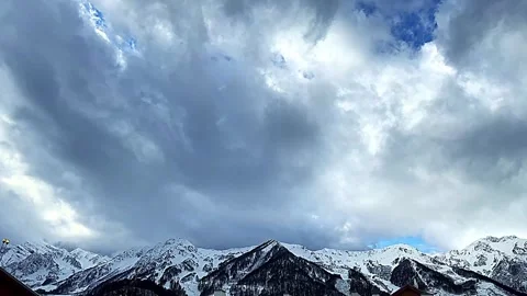A mountain range is visible in the background with a cloudy sky Vidéo 275326244