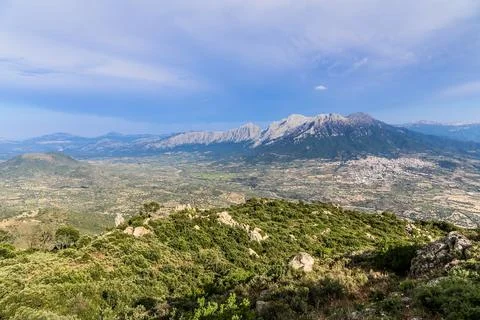 A mountain range is visible in the background with a town in the foreground.. Stock Photos