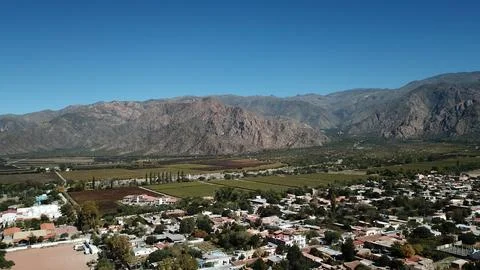 A mountain range is visible in the background of a town Stock Photos