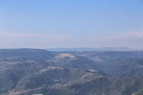 A mountain range is visible in the distance with a clear blue sky on the is.. Stock Photos
