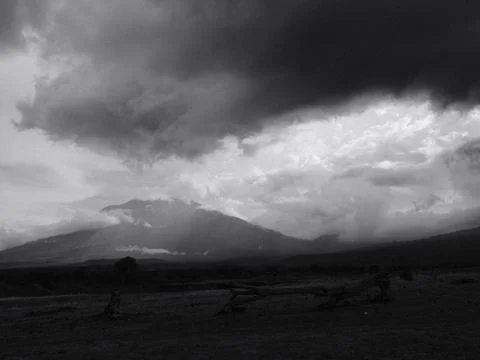 A mountain range is visible in the distance with a dark sky overhead Stock Photos