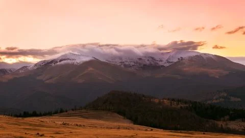 Mountain range with visible silhouettes through the morning colorful fog.Tarc Stock Photos