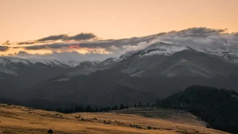 Mountain range with visible silhouettes through the morning colorful fog.Tarc Stock Photos