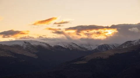 Mountain range with visible silhouettes through the morning colorful fog.Tarc Stock Photos
