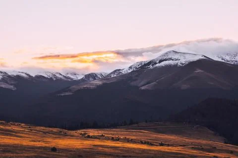 Mountain range with visible silhouettes through the morning colorful fog.Tarc Stock Photos