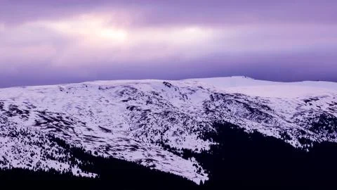 Mountain range with visible silhouettes through the morning colorful fog.Tarc Stock Photos