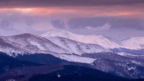 Mountain range with visible silhouettes through the morning colorful fog.Tarc Stock Photos
