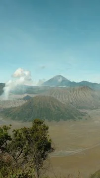 A mountain range with a volcano in the distance Foto stock