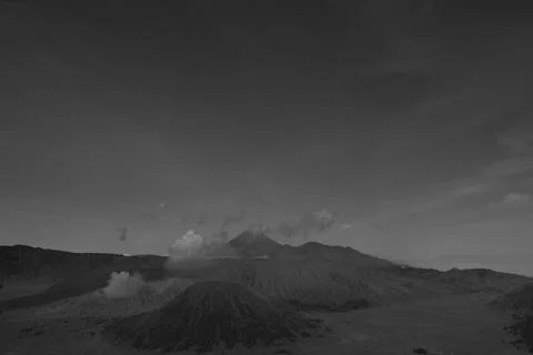 A mountain range with a volcano in the middle 스톡 사진