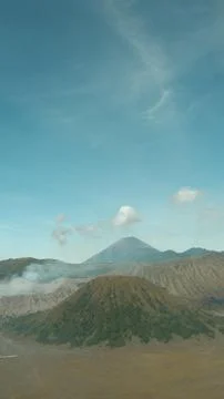 A mountain range with a volcano in the middle 스톡 사진