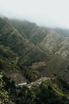 A mountain range with a winding road that runs through it Stock Photos