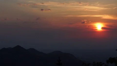 Mountain ranges and orange sunlight spread over during sunset Stock Footage 77811847