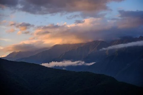 Mountain ranges in the clouds at sunset. Stock Photos