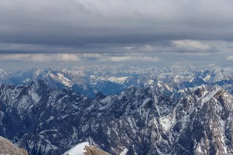 Mountain Ranges Covered in Snow with Cloudy Sky Stock Photos