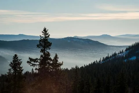 Mountain ranges with mist in the valleys Stock Photos