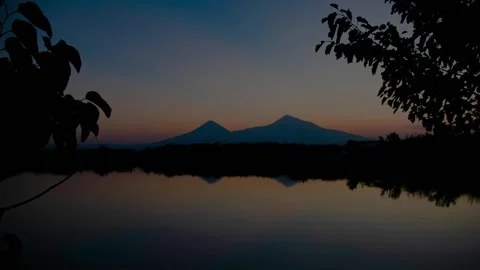 Mountain reflected in a calm lake during dusk at sunset Mount Ararat Stock Footage 347864770