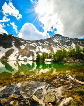 Mountain reflection in alpine tarn Stock Photos