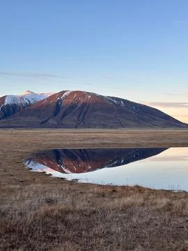 Mountain reflection in calm lake Stock Photos