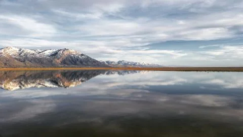 Mountain reflection with dramatic sky Stock Photos