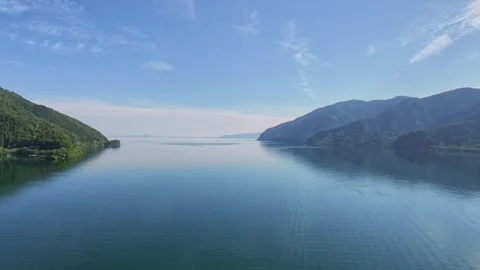 Mountain Reflections on Lake Biwa with Forested Peninsula Japan Stock Footage 336406499