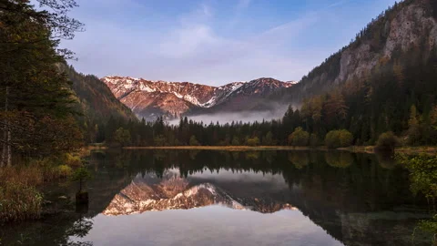 Mountain reflections in a small lake after sunrise timelapse Stock Footage 143269219