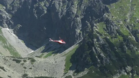 Mountain Rescue Helicopter Flying on Tourist Rescue Mission in High Mountains Stock Footage 138843407