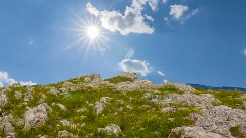 Mountain ridge among green hills under sparkle sun Video stock 316846653