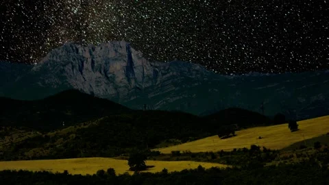 Mountain ridge and fields at night under a starry night sky and Milky Way Galaxy Stock Footage 347864902