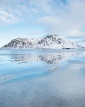 Mountain ridge and reflection on the seashore Stock Photos