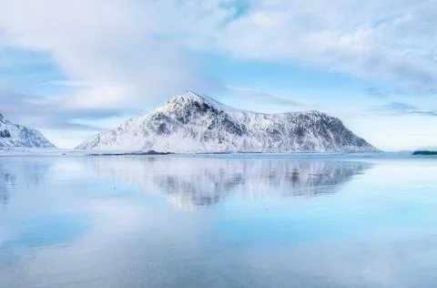 Mountain ridge and reflection on the seashore Stock Photos