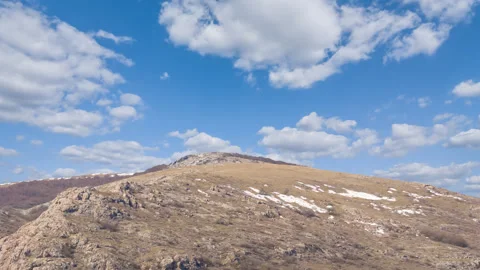 Mountain ridge on blue cloudy sky time lapse scene Stock Footage 246803370